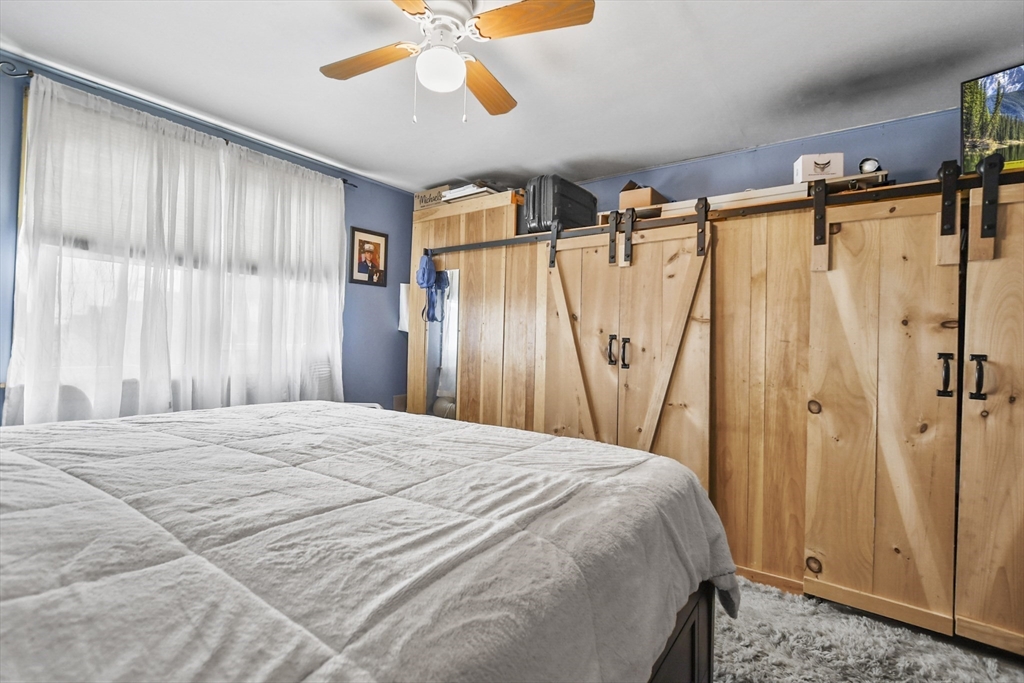 82 Cedar Street Everett, MA 02149 - Photo 18 of 41 a bedroom with a bed and a mirror