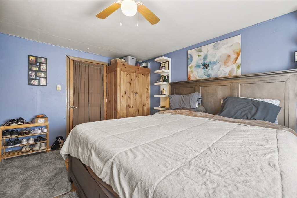 82 Cedar Street Everett, MA 02149 - Photo 19 of 41 a bedroom with a bed and a chandelier