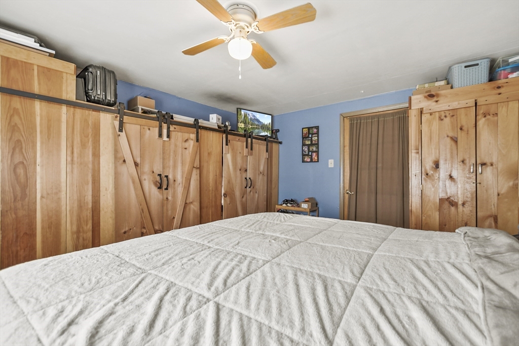 82 Cedar Street Everett, MA 02149 - Photo 20 of 41 a bedroom with a bed and a chandelier