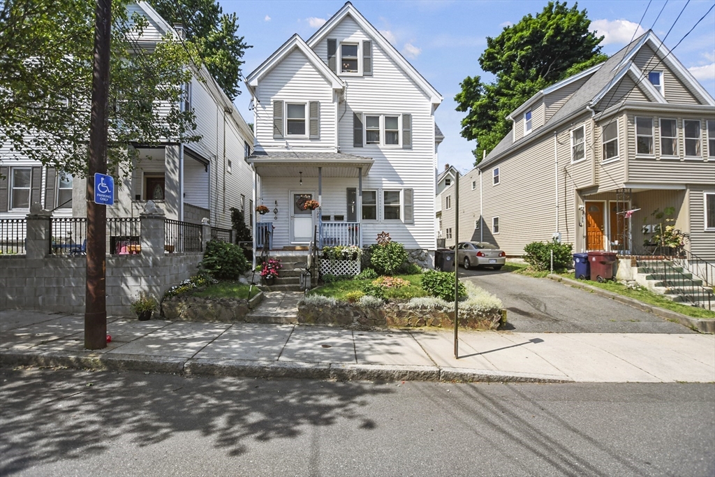 82 Cedar Street Everett, MA 02149 - Photo 2 of 41 a view of white house with a yard and large tree