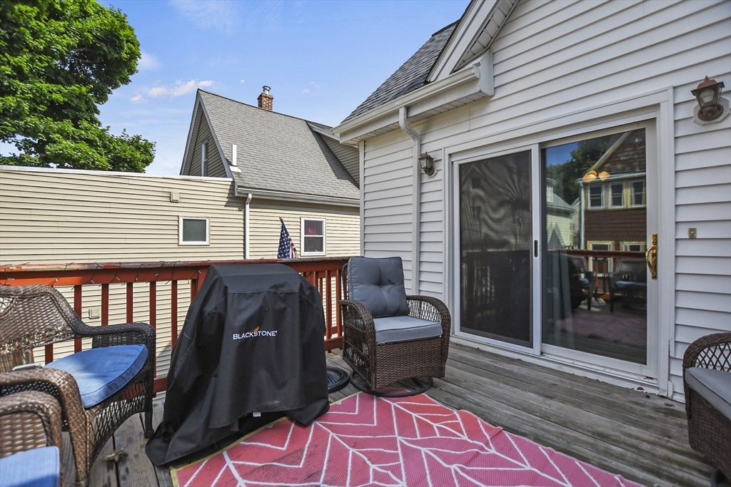82 Cedar Street Everett, MA 02149 - Photo 22 of 41 a view of a patio with table and chairs with wooden floor and fence