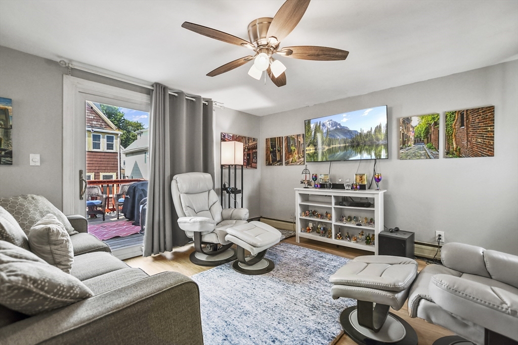 82 Cedar Street Everett, MA 02149 - Photo 25 of 41 a living room with furniture a large window and gym equipment