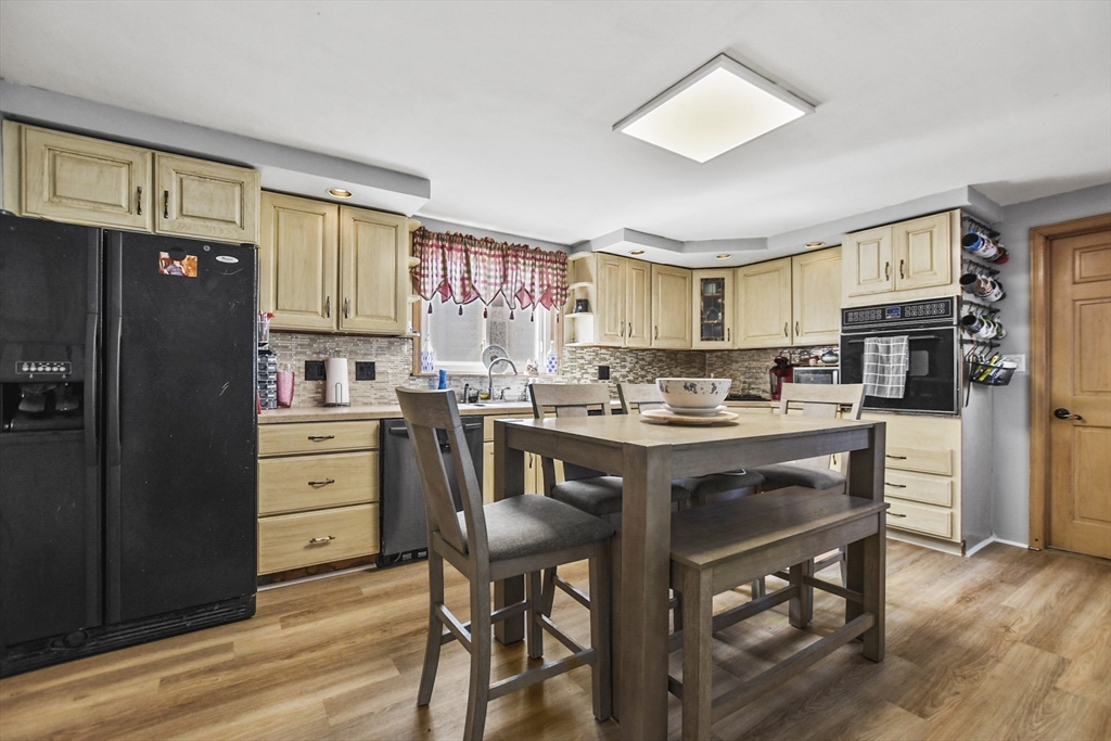 82 Cedar Street Everett, MA 02149 - Photo 26 of 41 a kitchen with a refrigerator a stove a sink and dishwasher with wooden floor