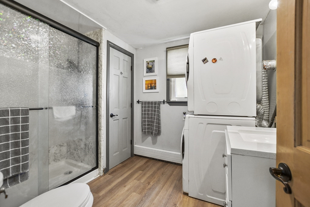 82 Cedar Street Everett, MA 02149 - Photo 29 of 41 a white refrigerator freezer and a wooden floor in a room