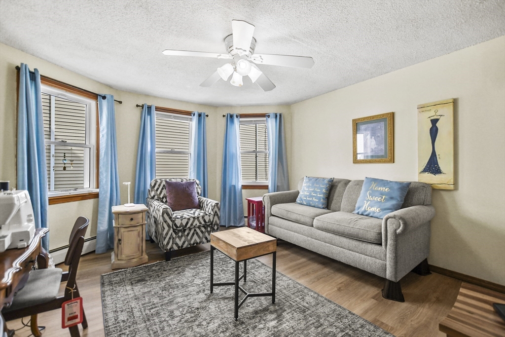 82 Cedar Street Everett, MA 02149 - Photo 9 of 41 a living room with furniture and large windows