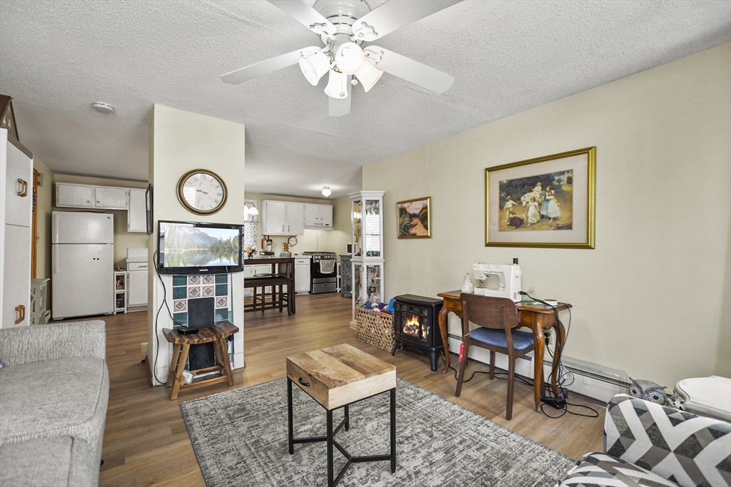 82 Cedar Street Everett, MA 02149 - Photo 10 of 41 a living room with furniture a clock on wall and a table