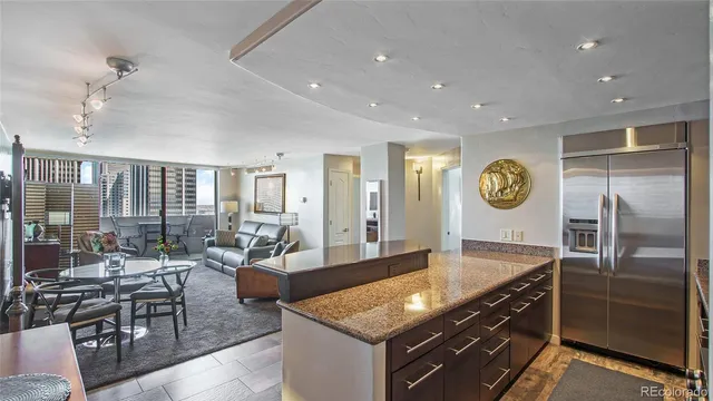 a kitchen with stainless steel appliances granite countertop a stove and a refrigerator