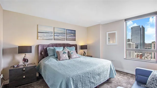 a bedroom with a large bed and a couch