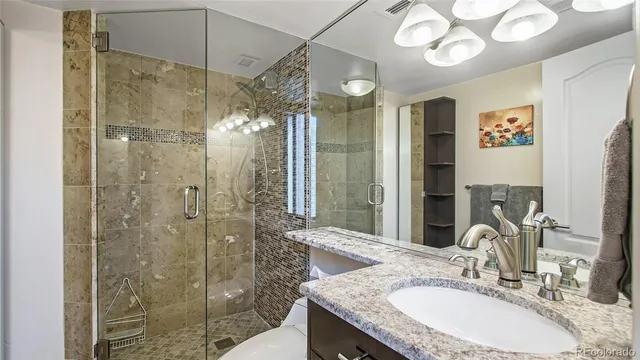a bathroom with a granite countertop shower sink and mirror