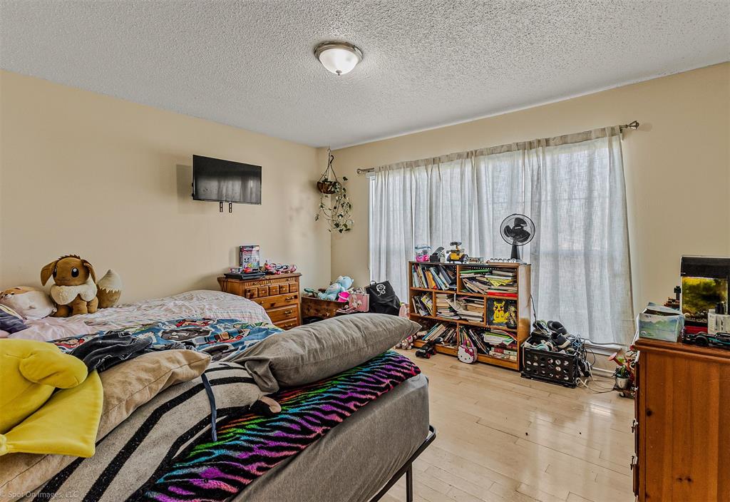 7910 Northaven Road, Unit B Dallas, TX 75230 - Photo 12 of 27 a bedroom with furniture and a bed