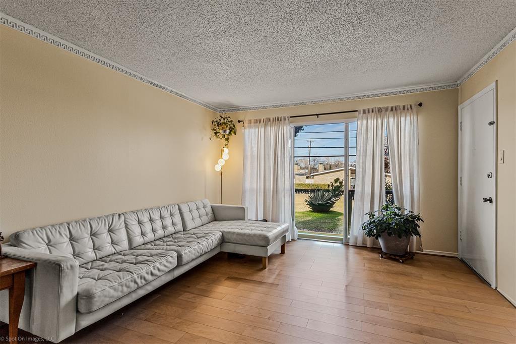7910 Northaven Road, Unit B Dallas, TX 75230 - Photo 2 of 27 a living room with furniture and wooden floor