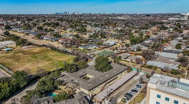 an aerial view of a residential houses with city view