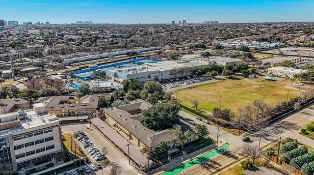 an aerial view of a residential building and an ocean