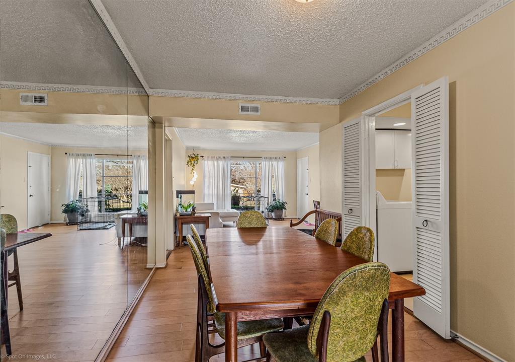 7910 Northaven Road, Unit B Dallas, TX 75230 - Photo 5 of 27 a view of a dining room with furniture and wooden floor