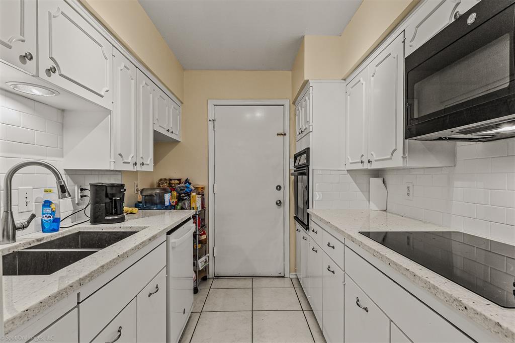 7910 Northaven Road, Unit B Dallas, TX 75230 - Photo 6 of 27 a kitchen with stainless steel appliances a sink a stove and cabinets