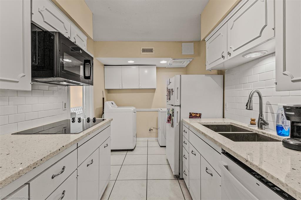 7910 Northaven Road, Unit B Dallas, TX 75230 - Photo 8 of 27 a kitchen with a sink and refrigerator