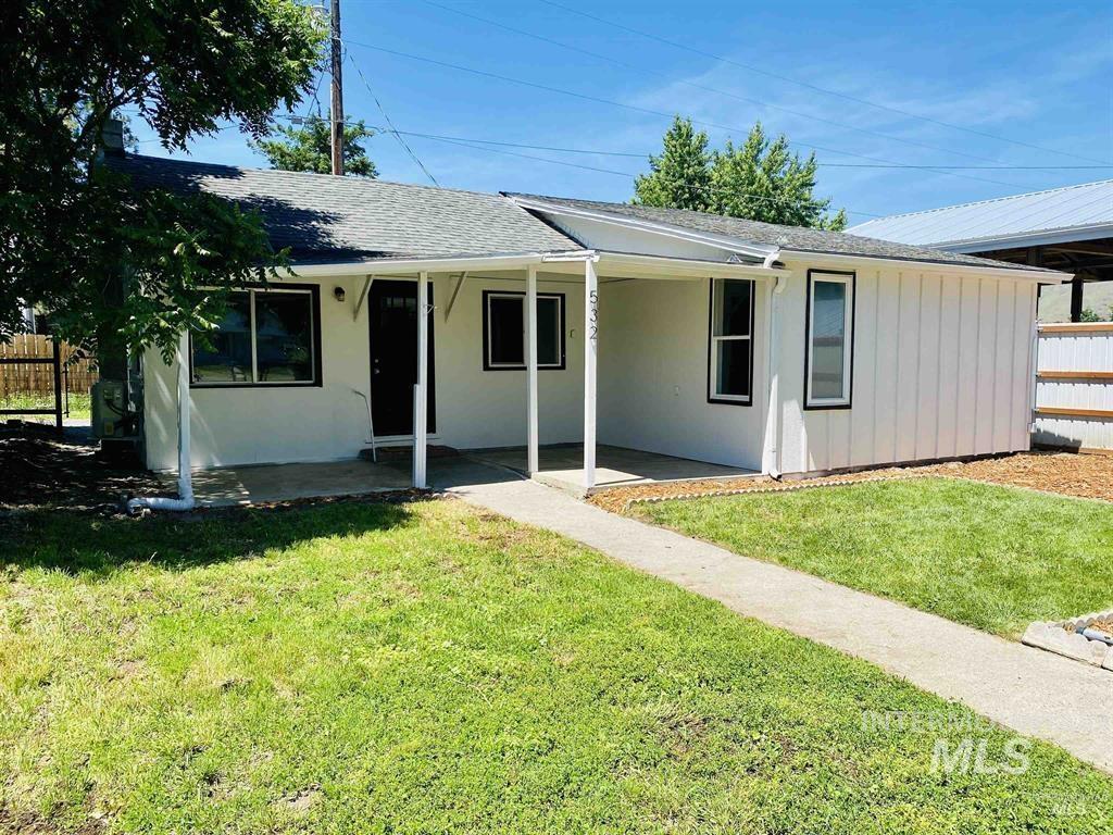 View of front of property featuring covered porch, a shingled roof, and board and batten siding