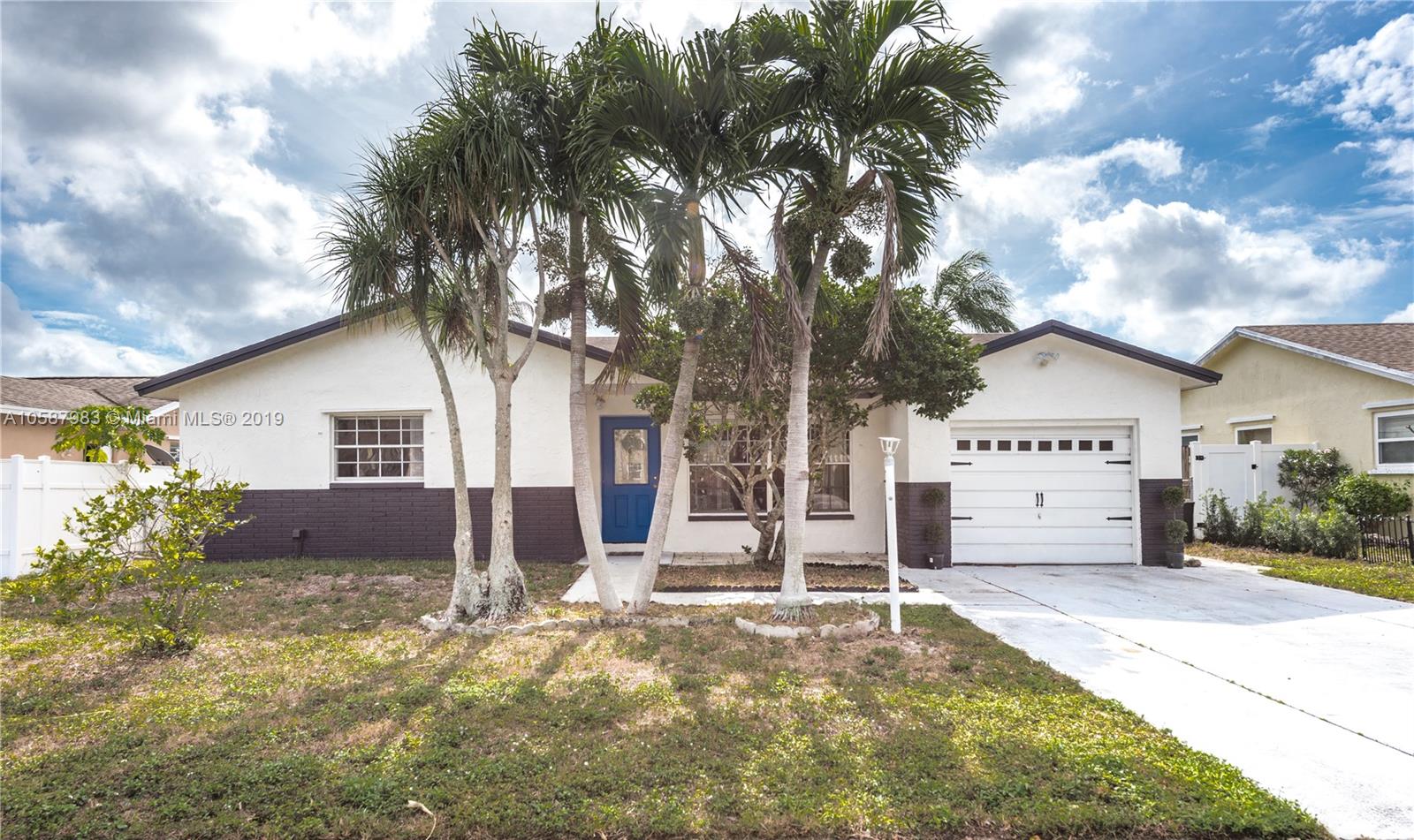8912 Southwest 6th Street Boca Raton, FL 33433 - Photo 1 of 19 a view of a house with a yard covered in snow