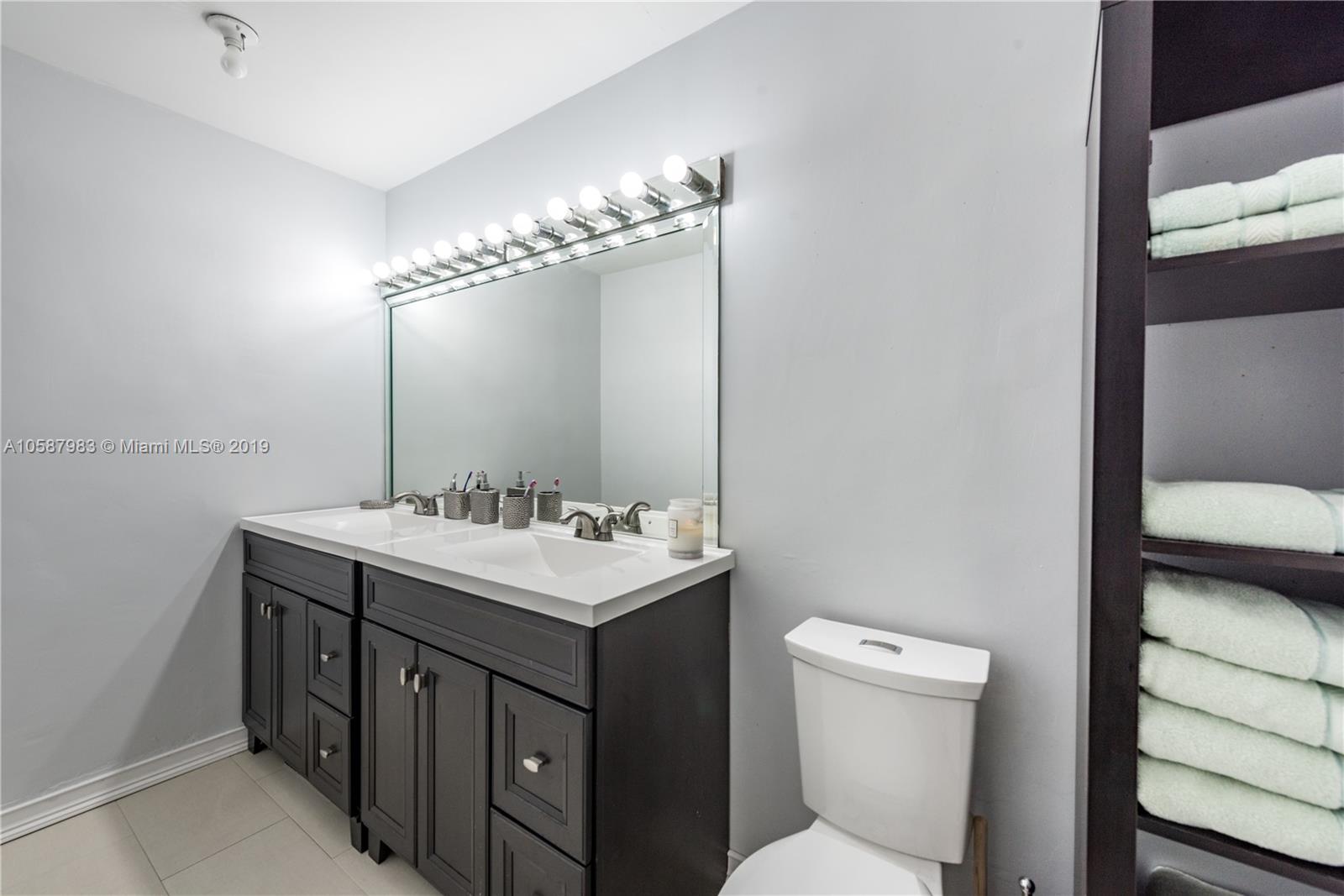 8912 Southwest 6th Street Boca Raton, FL 33433 - Photo 11 of 19 a bathroom with a toilet sink and mirror