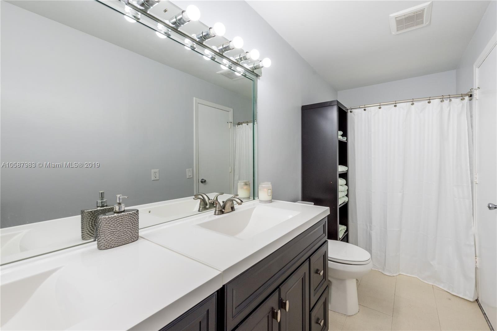 8912 Southwest 6th Street Boca Raton, FL 33433 - Photo 12 of 19 a bathroom with a sink toilet and shower