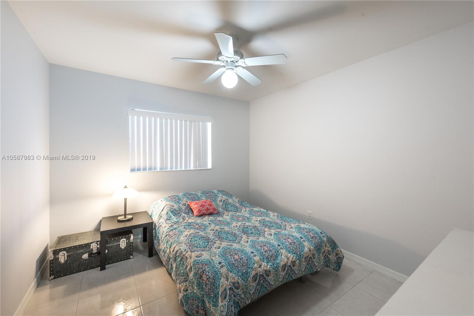 8912 Southwest 6th Street Boca Raton, FL 33433 - Photo 15 of 19 a bedroom with a bed and a chandelier