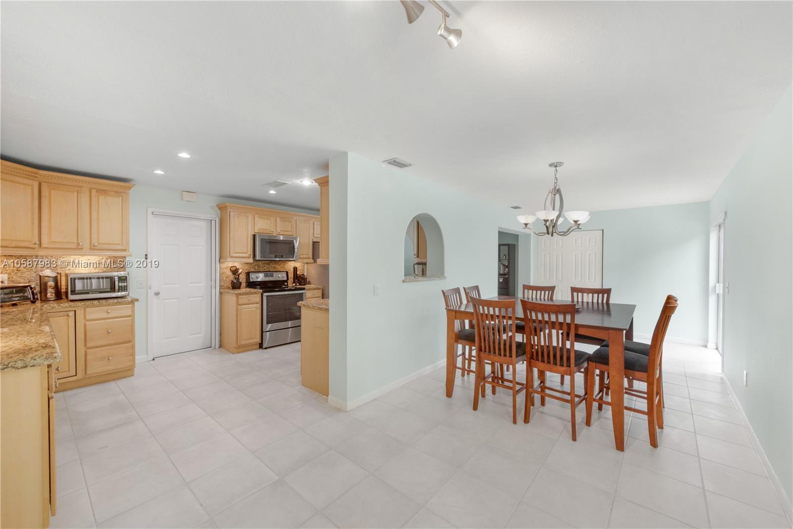 8912 Southwest 6th Street Boca Raton, FL 33433 - Photo 2 of 19 a view of a dining room with furniture and chandelier