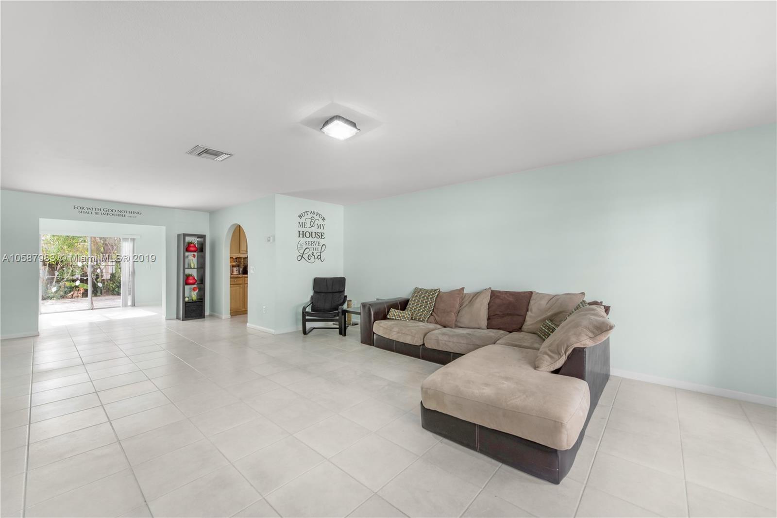 8912 Southwest 6th Street Boca Raton, FL 33433 - Photo 10 of 19 a living room with furniture and a flat screen tv