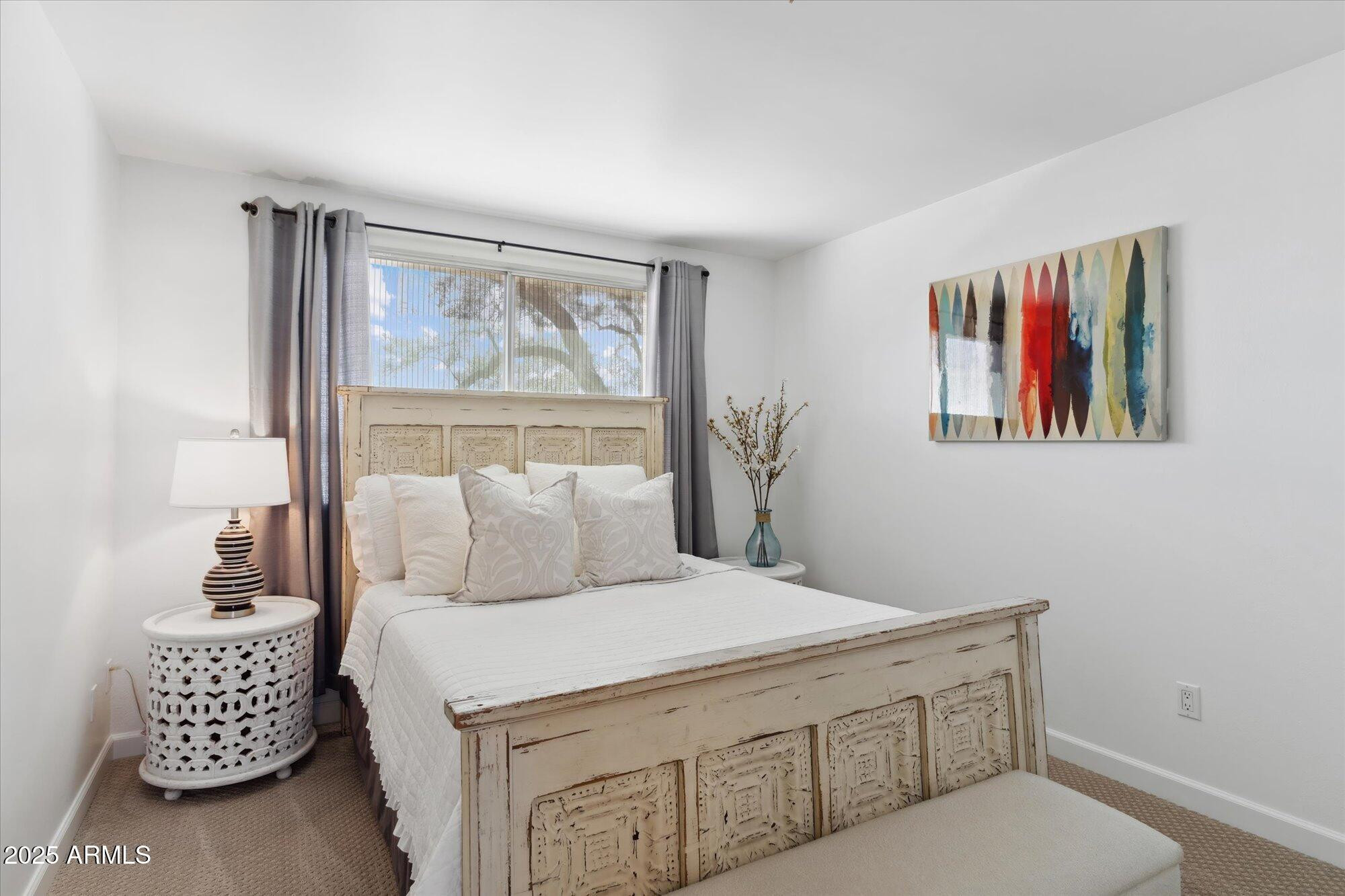 5020 North Granite Reef Road Scottsdale, AZ 85250 - Photo 18 of 24 a bedroom with a large bed and a painting on the wall