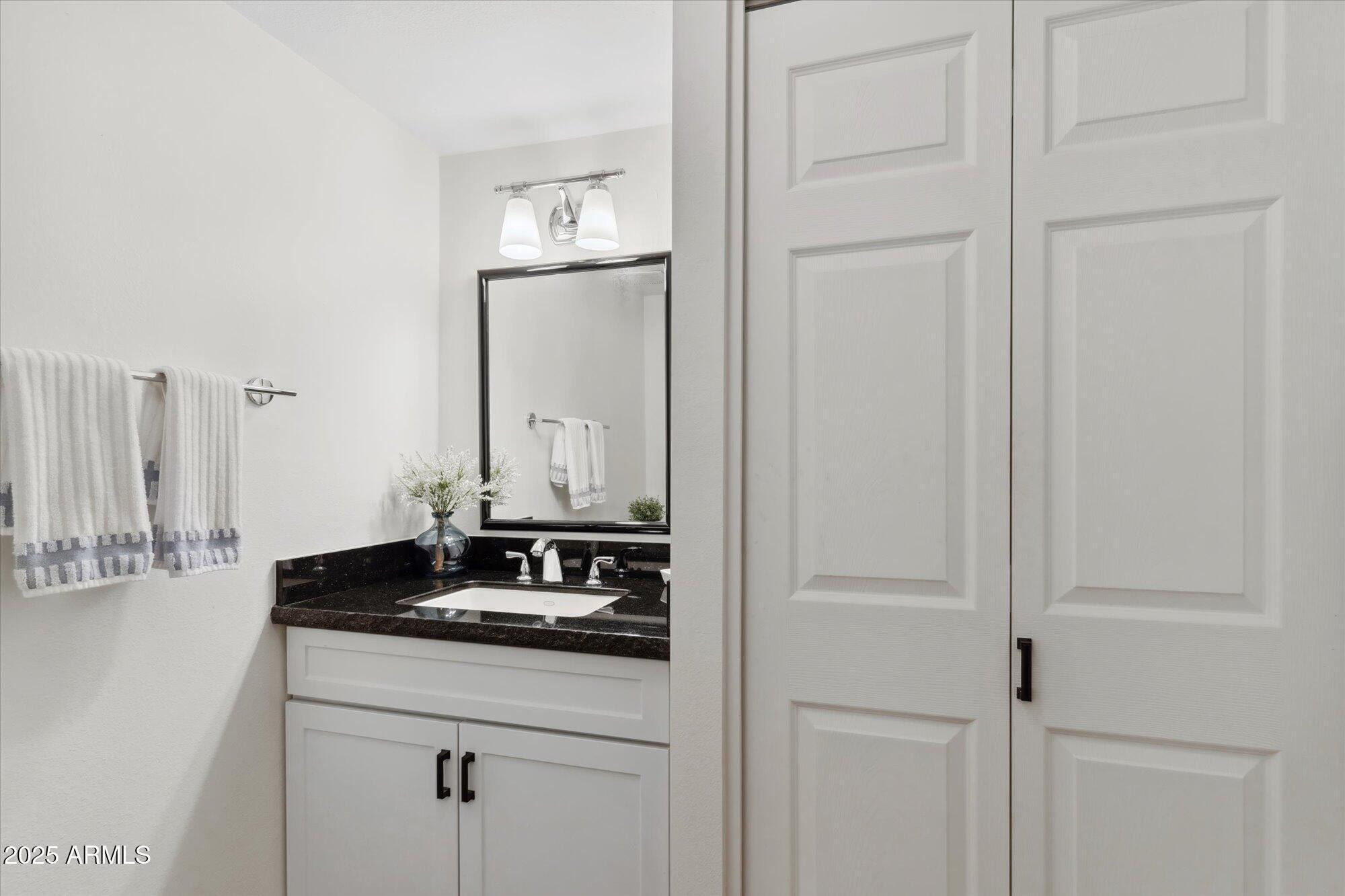 5020 North Granite Reef Road Scottsdale, AZ 85250 - Photo 9 of 24 a bathroom with a granite countertop sink and a mirror