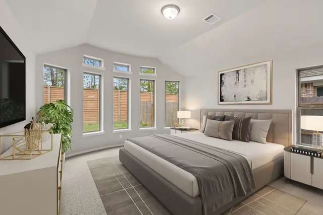 a spacious bedroom with a large bed and a large window