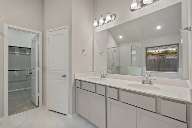 a bathroom with a sink double vanity and a mirror