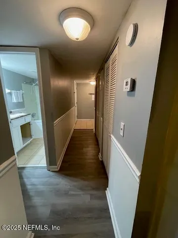 a view of a hallway view with wooden floor and staircase