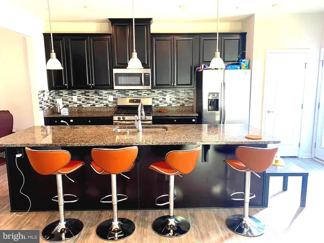 a living room with furniture chess table and a chandelier