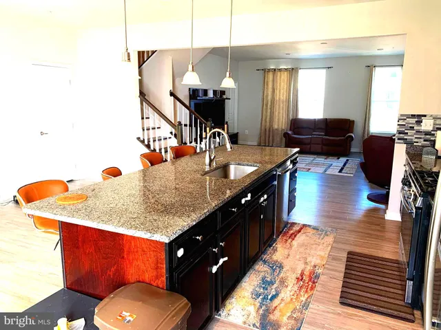 a bathroom with a granite countertop sink a large mirror and vanity