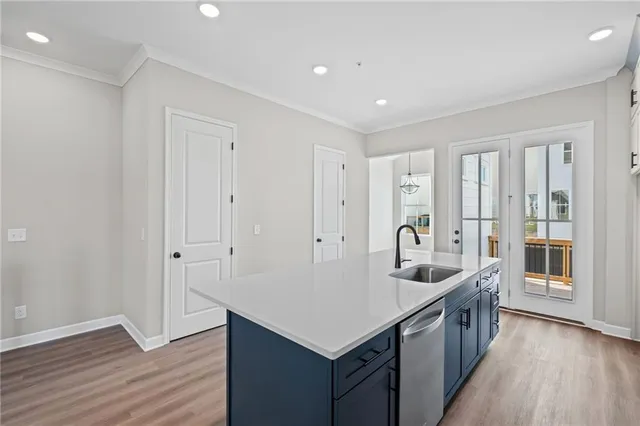 a kitchen with counter top space and wooden floor