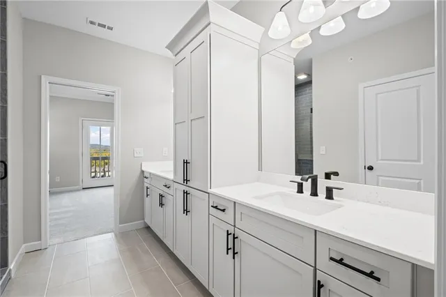 a bathroom with double vanity sinks and a mirror