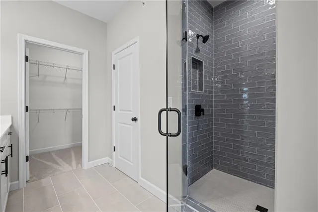 a bathroom with a glass shower door