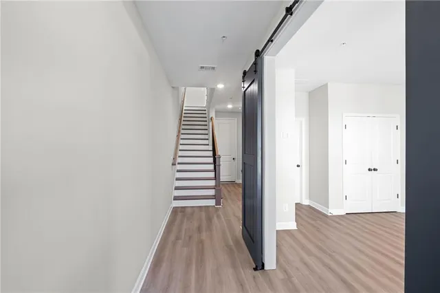 a view of a hallway with wooden floor