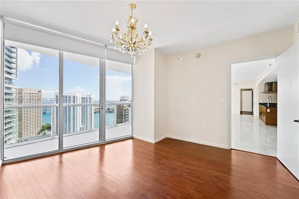 a view of wooden floor and windows in a room