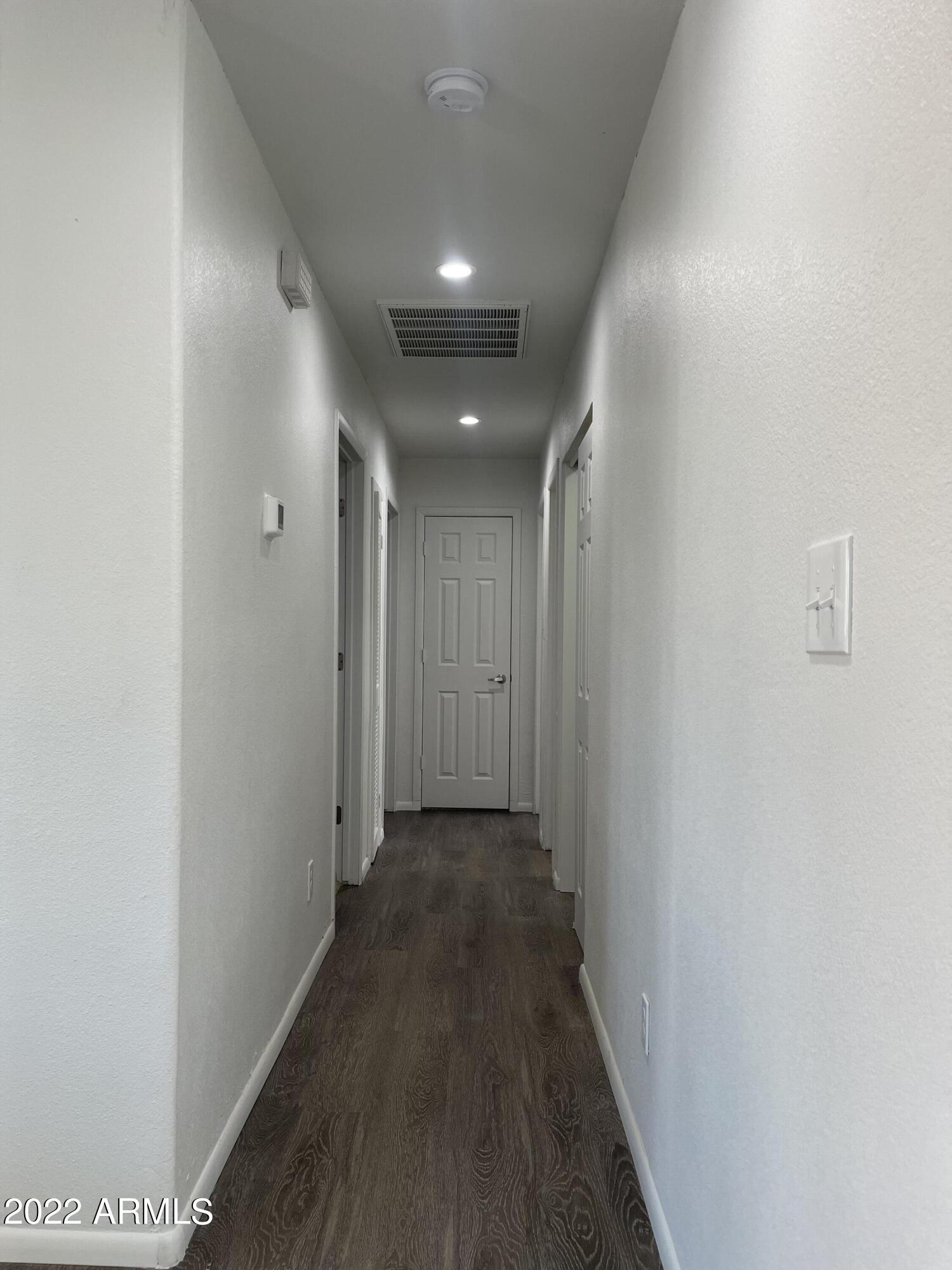 5207 West Osborn Road Phoenix, AZ 85031 - Photo 29 of 35 a view of hallway with wooden floor