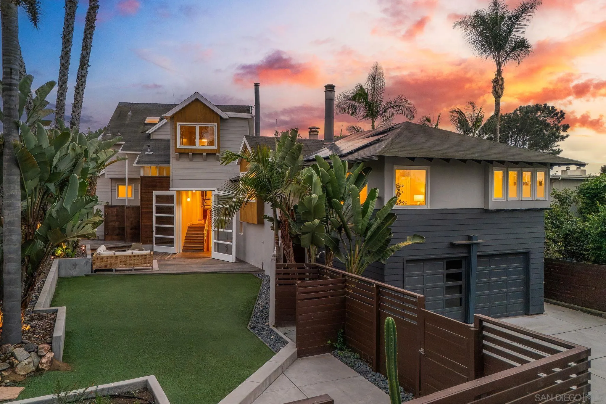 a front view of a house with a garden and yard