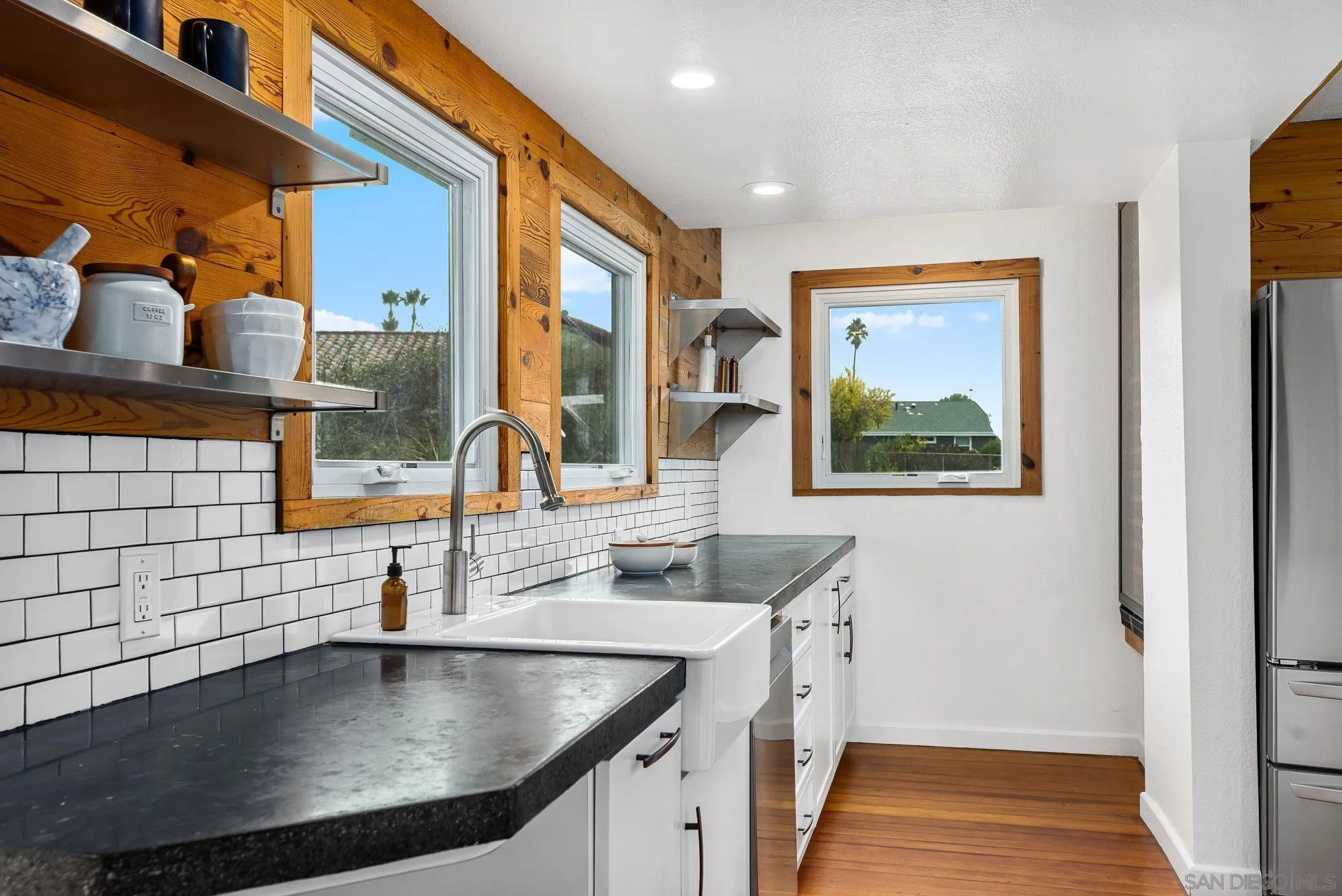 445 Sheffield Avenue Cardiff, CA 92007 - Photo 26 of 62 a kitchen with stainless steel appliances granite countertop a sink and a window