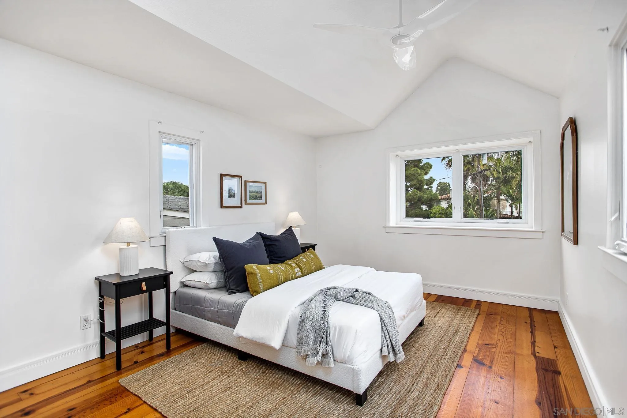 445 Sheffield Avenue Cardiff, CA 92007 - Photo 47 of 62 a bedroom with a bed and wooden floor