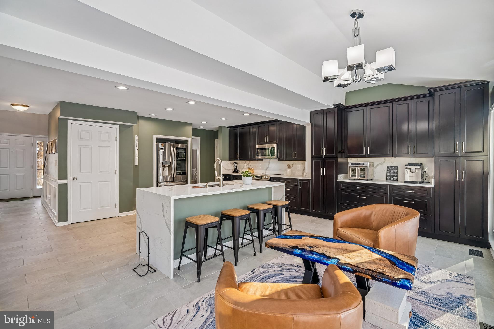 454 North Patuxent Road Odenton, MD 21113 - Photo 9 of 41 a dining room with furniture a chandelier and kitchen view