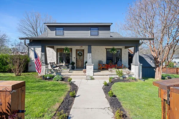 a view of a house with garden and patio