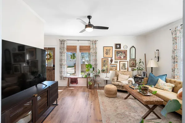 a dining room with furniture a chandelier and wooden floor