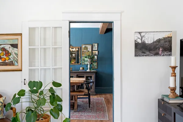 a view of a hallway with wooden floor and entryway
