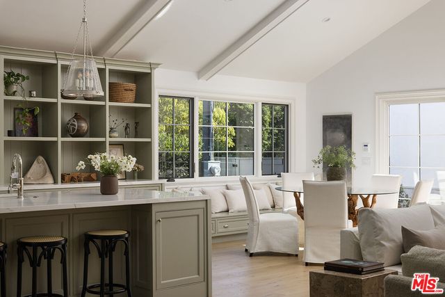 a living room with furniture and large windows