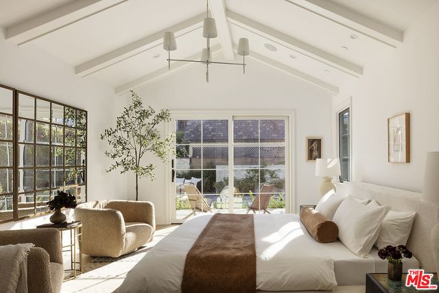 a bathroom with a double vanity sink a mirror a shower and a bath tub