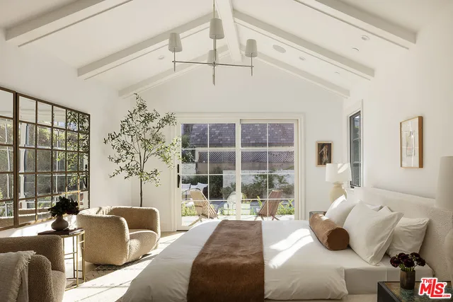 a bathroom with a double vanity sink a mirror a shower and a bath tub